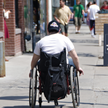 Person in wheelchair on sidewalk
